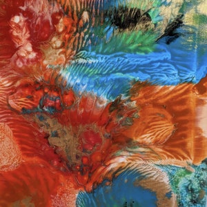 May include: Abstract painting with swirling colors of red, orange, blue, green, and gold. The colors blend and overlap, creating a dynamic and energetic composition.