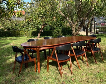 Mid Century Teak Dining Set Model 62 Table For Henning Kjærnulf For Sorø Stolefabrik And Eight Model 31 Kai Kristiansen Chairs in black.