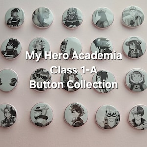 May include: A collection of 16 round buttons featuring characters from the anime My Hero Academia. The buttons are black and white and feature characters from Class 1-A. The buttons are arranged in a grid pattern on a light pink background.