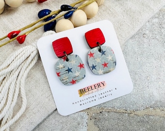 May include: Red and blue wooden earrings with a star pattern. The earrings are on a white card with the text "BEELERY Handmade with love Handcrafted Leather & Macrame Jewelry".