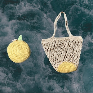 May include: A crocheted lemon-shaped bag with a white crocheted handle and a yellow crocheted lemon design. The bag is on a blue and white textured background.