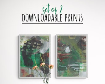 May include: Set of two downloadable abstract art prints in green, black, white, and brown tones. The prints are framed and displayed on a white wall above a wooden table with two chairs.