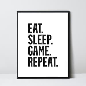 May include: Black and white printable wall art with the text "EAT. SLEEP. GAME. REPEAT."