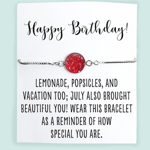 May include: A silver bracelet with a red glitter charm that says "Happy Birthday!"  The card reads "Lemonade, popsicles, and vacation too; July also brought beautiful you! Wear this bracelet as a reminder of how special you are."  The card is signed "glitter & GUMDROPS".