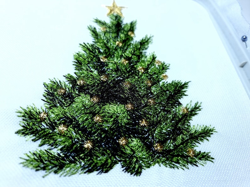 May include: Embroidered Christmas tree design with a gold star on top and gold ornaments throughout the green tree.