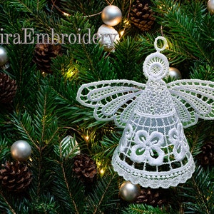 May include: White lace angel ornament hanging on a green Christmas tree with silver ornaments and pine cones.