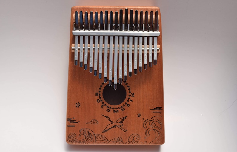 Front face of the kalimba thumb piano 17 key bird and ocean wave design.