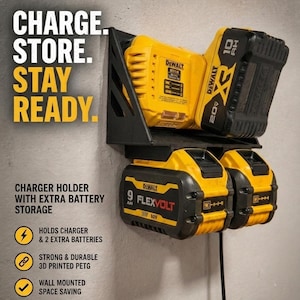 May include: A black and yellow wall-mounted charger holder with extra battery storage. The holder is designed to hold a charger and two extra batteries. The text on the holder says "CHARGE. STORE. STAY READY."