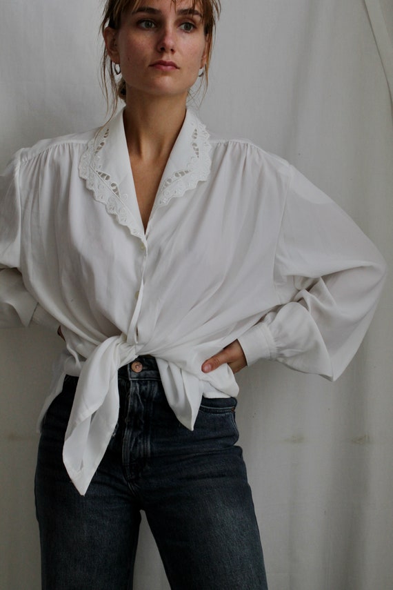 White vintage blouse with lace collar in folklore