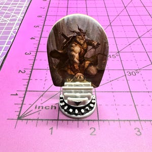 May include: A set of three ceramic mugs with a speckled, matte finish. Each mug features a different color: light blue, cream, and gray. The mugs have a simple, modern design with a rounded shape and a comfortable handle.