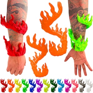 May include: A collection of flame-shaped wrist cuffs in various colors, including red, orange, and green. The cuffs are shown worn on a wrist and arm, and also displayed individually. A rainbow of additional color options are shown at the bottom.