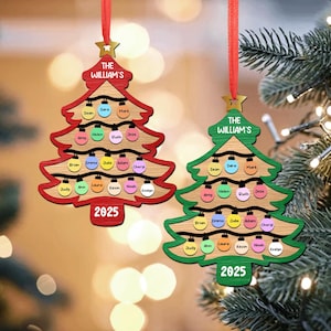 May include: Two wooden Christmas tree ornaments with the text "THE WILLIAM'S" and "2025". Each tree has colorful lights and names. One is red and the other is green, both with a red ribbon for hanging.