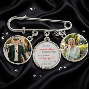 May include: A silver-toned graduation pin with three circular pendants. Two pendants display photos of people, while the central pendant has the text "ON YOUR graduation DAY, KNOW THAT I AM WALKING beside YOU EVERY STEP OF THE WAY."
