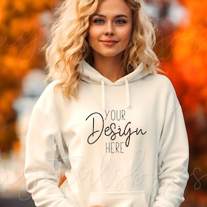 May include: A white hoodie with a drawstring hood and a kangaroo pocket. The hoodie has the text "YOUR DESIGN HERE" printed on the front.