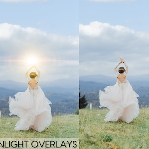 May include: A bride in a white wedding dress with her arms raised in the air, standing on a grassy hill with a mountain range in the background. The sun is shining brightly behind her, creating a lens flare effect.