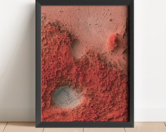 May include: A framed abstract print of a red and grey textured surface, resembling a Martian landscape.