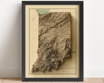 Op de afbeelding: Een ingelijste vintage kaart van de staat Indiana met een 3D-reliëfeffect. De kaart is in tinten bruin en beige met zwarte lijnen en tekst. De tekst op de kaart luidt "State of Indiana".