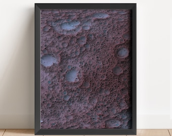 May include: A framed abstract art print with a textured, bubble-like pattern in shades of purple and blue.