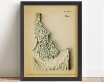 May include: A framed relief map of Idaho with a vintage aesthetic. The map is printed on a cream-colored paper with a textured surface. The title "Relief Map of Idaho" is printed in black at the top of the map.