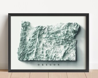 Puede incluir: Una impresión enmarcada de un mapa topográfico 3D de Oregón. El mapa está en tonos de verde y blanco, con el nombre del estado impreso debajo.