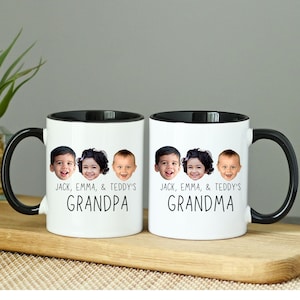 May include: Two white ceramic mugs with black handles and black rims. Each mug has a photo of three children's faces and the text "JACK, EMMA, & TEDDY'S GRANDPA" and "JACK, EMMA, & TEDDY'S GRANDMA".