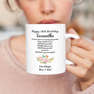 May include: White ceramic mug with a floral design and the text "Happy 18th Birthday, Samantha. You have grown into an amazing young woman! Always remember, You are BRAVER than you believe, STRONGER than you seem, SMARTER than you think and twice as BEAUTIFUL as you ever imagined. Love always, Mom & Dad."