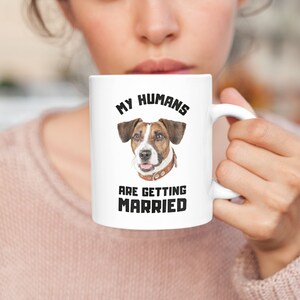 May include: White ceramic mug with a brown and white dog illustration and the text "My Humans Are Getting Married".