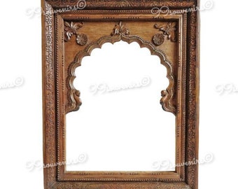 May include: A wooden frame with intricate carvings, featuring an arched opening. The frame is a rich brown color and has a traditional Indian design.
