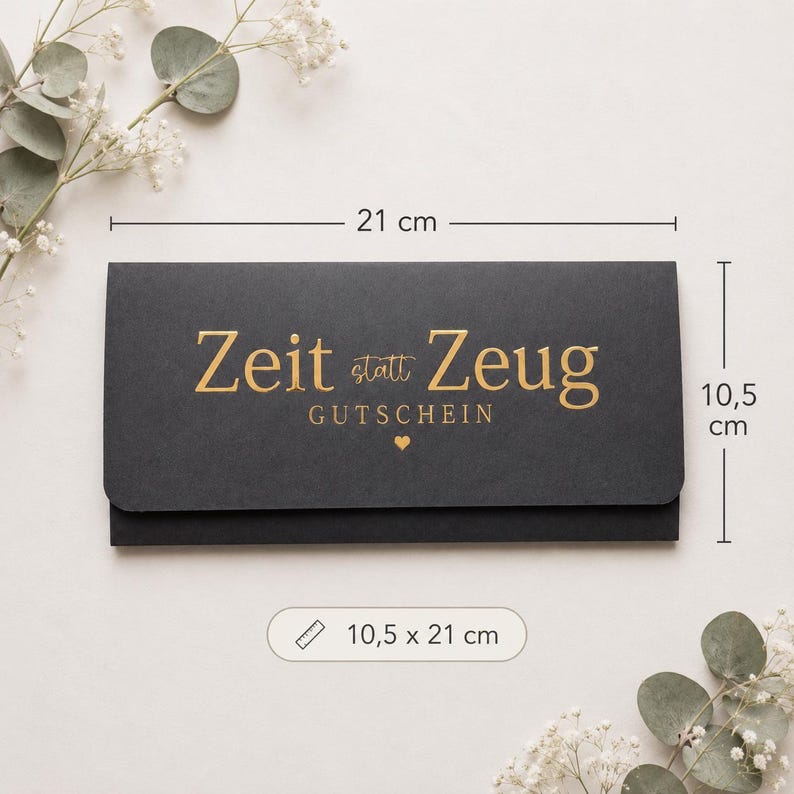May include: A rectangular black gift voucher envelope featuring gold foil text that reads Zeit statt Zeug GUTSCHEIN with a small heart icon. The envelope measures 8.27 inches by 4.13 inches as indicated by the visible dimension markers.