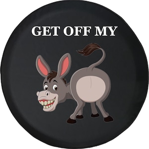 May include: Black spare tire cover featuring a cartoon donkey with a large grin. The text "GET OFF MY" is printed in white at the top. The donkey is gray with pink ears and a brown tail.