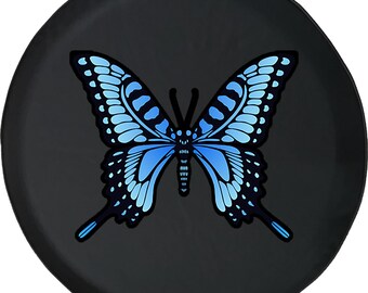 May include: Black spare tire cover featuring a large, stylized butterfly. The butterfly has a detailed design with shades of blue and black, set against a solid black background. The cover is round.