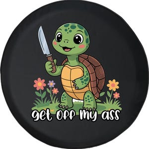May include: Black spare tire cover featuring a cartoon turtle holding a knife, with the text "get off my ass" in white. The turtle is green with a brown shell, standing in a field of flowers.