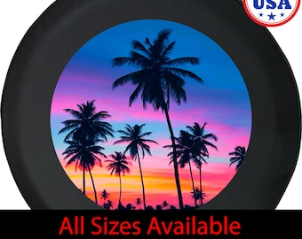May include: Black tire cover featuring a tropical sunset scene with palm tree silhouettes against a vibrant pink, orange, and blue sky. The text "All Sizes Available" is displayed at the bottom. Made in USA.