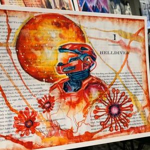 May include: A rectangular art print featuring a red armored figure in a helmet, set against a background of printed book text. A large orange sphere sits behind the figure, with red floral-like shapes and orange paint splatters throughout.