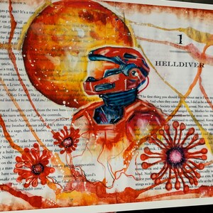 May include: An artistic print on a book page featuring a red armored figure in a helmet, a large orange circular shape, and red floral-like patterns. The text "1 HELLDIVER" is printed in black ink above the figure, overlaid on printed text.