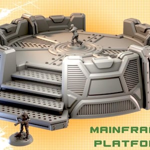 May include: A grey, futuristic Mainframe Platform with steps and a circular central area. The platform has a detailed design with rivets and panels. Two miniature figures are positioned on the platform. The text "MAINFRAME PLATFORM" is displayed.