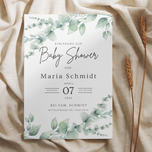May include: A baby shower invitation with a white background, adorned with watercolor eucalyptus leaves. The invitation includes the text "Baby Shower" and details for Maria Schmidt's baby shower on April 7, 2024, in Cologne.
