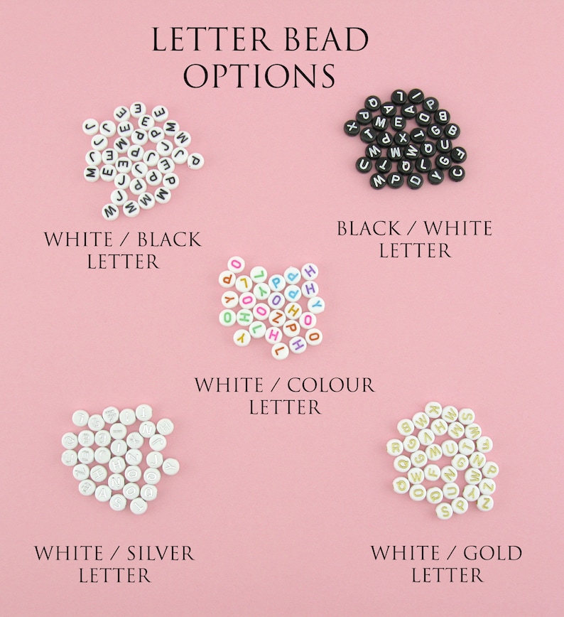May include: Four different color combinations of letter beads. White beads with black letters, white beads with colorful letters, white beads with silver letters, and white beads with gold letters.