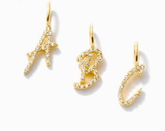 May include: Three gold-tone metal letter pendants shaped as A, B, and C. Each letter features a polished gold finish and is encrusted with small, clear, sparkling stones along the front surface. Each pendant includes a small gold jump ring at the top.