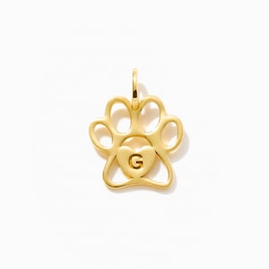 May include: A gold-toned metal pendant shaped like an animal paw print. The centre of the paw pad features a small, raised heart shape with the capital letter G embossed in the middle. A small circular jump ring is attached to the top of the charm.