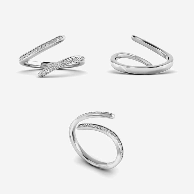 Pu&ograve; includere: Tre immagini di un anello d'argento dal design unico e aperto. Un anello presenta una fascia foderata con piccole pietre trasparenti. Gli altri due anelli hanno una superficie liscia e lucida. Il design dell'anello si curva e si sovrappone, creando un look elegante e moderno. Gioielli.