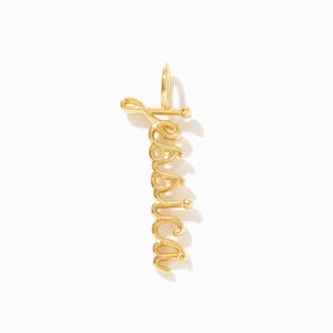 May include: Gold charm necklace with the name "Jessica" spelled out in a cursive font.