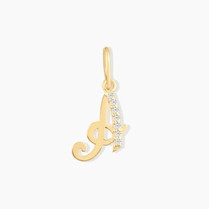 May include: A gold pendant in the shape of the letter A, featuring a cursive script design. The right side of the letter is accented with a vertical row of six small, clear, round-cut stones. A small gold jump ring is attached to the top.