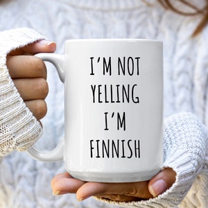 May include: White ceramic mug with black text that reads "I'm not yelling I'm Finnish".