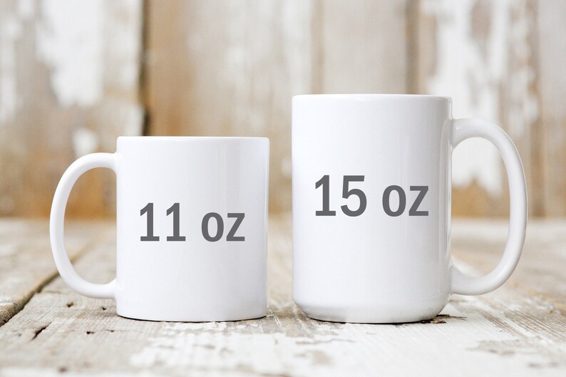 May include: Two white ceramic mugs with black text. The smaller mug is 11 oz and the larger mug is 15 oz.