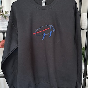 May include: Black sweatshirt with a blue and red embroidered design of a pig on the front.