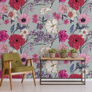 May include: A floral wallpaper with a light gray background featuring a variety of pink, red, and white flowers. The flowers are arranged in a repeating pattern and are surrounded by green leaves.