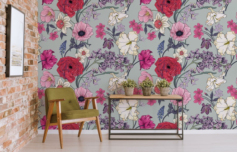 May include: A floral wallpaper with a light gray background featuring a variety of pink, red, and white flowers. The flowers are arranged in a repeating pattern and are surrounded by green leaves.