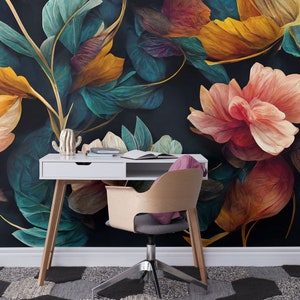May include: A white desk with a wooden chair sits in front of a dark floral wallpaper. The wallpaper features large, colorful flowers and leaves in shades of teal, yellow, pink, and red.