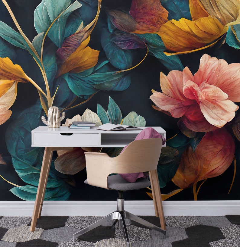 May include: A white desk with a wooden chair sits in front of a dark floral wallpaper. The wallpaper features large, colorful flowers and leaves in shades of teal, yellow, pink, and red.